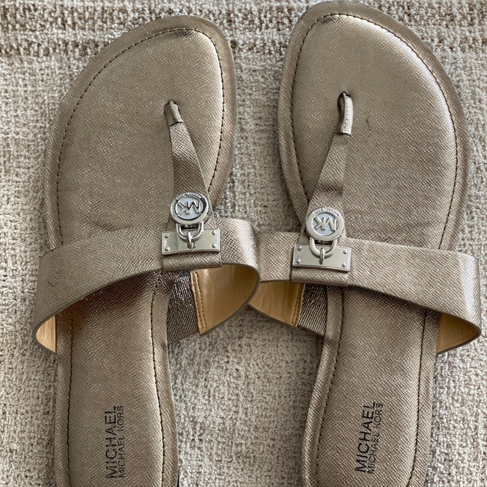 Michael Kors metallic slip on sandals.